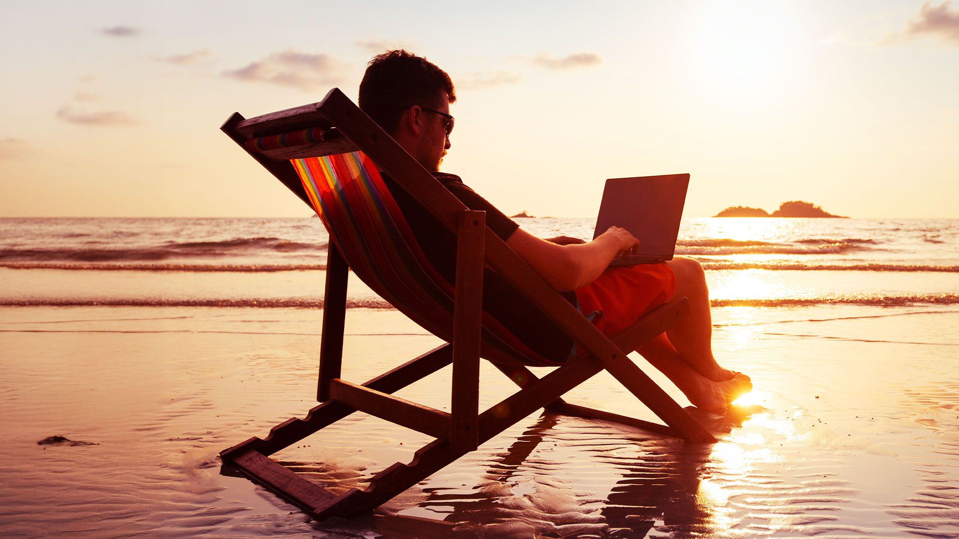 Working remotely with laptop - stunning beach and mountain views